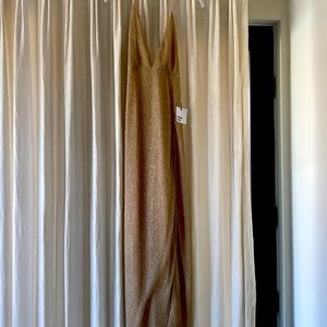 XS gold dress never been worn open back front slit. Low cut front